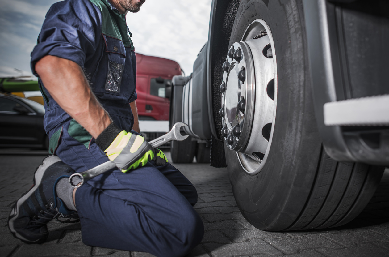 Mechanic Fixing Tire of Truck